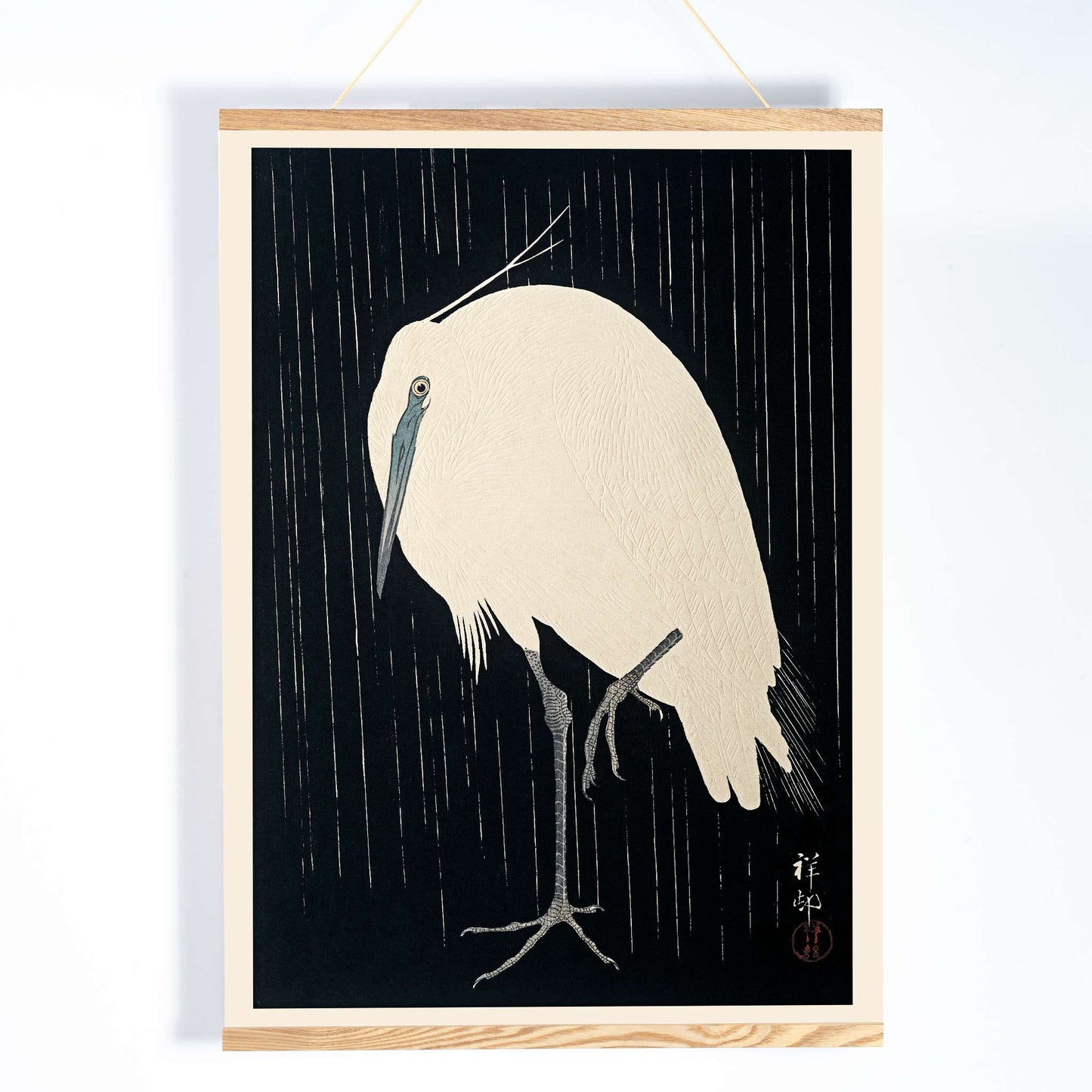 White egret standing in the rain art print poster with dark background by Ohara Koson, with wooden magnetic frame on white background
