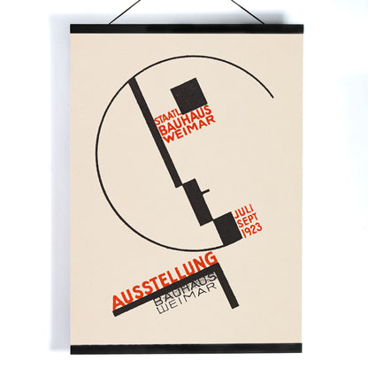 Dörte Helm Bauhaus Weimar exhibition poster with bold black geometry and red typography on warm beige background, with wooden magnetic frame on white background