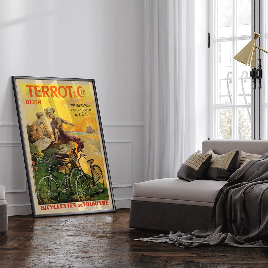 Vintage poster Terrot And Cie Dijon Bicyclettes De Tourisme by Armand Masson showing a couple with touring bicycles overlooking the coast at sunset, framed and displayed in home decor