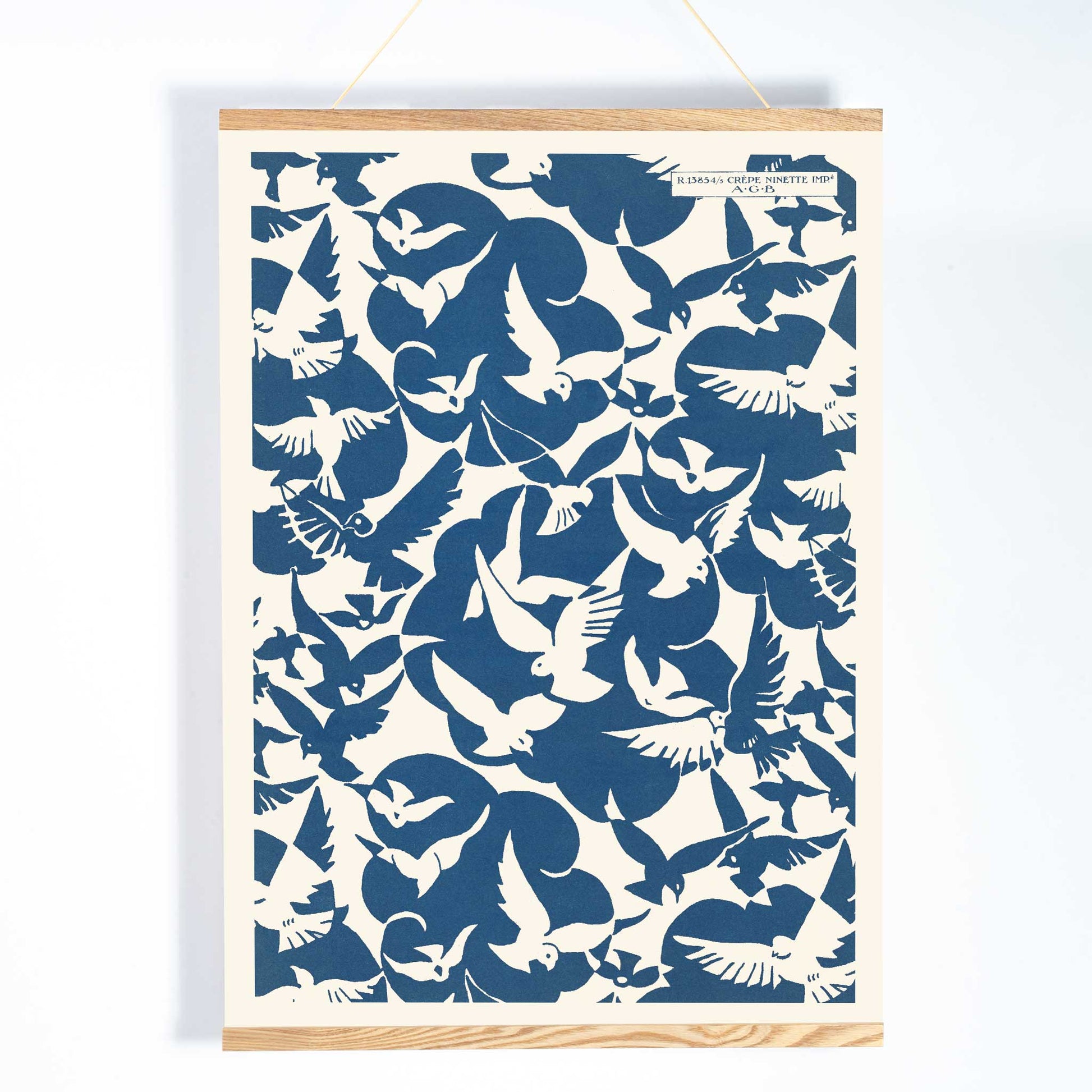 Charles Goy Lesbesse crepe poster with stylized birds in bold blue and cream minimalist design, with wooden magnetic frame on white background