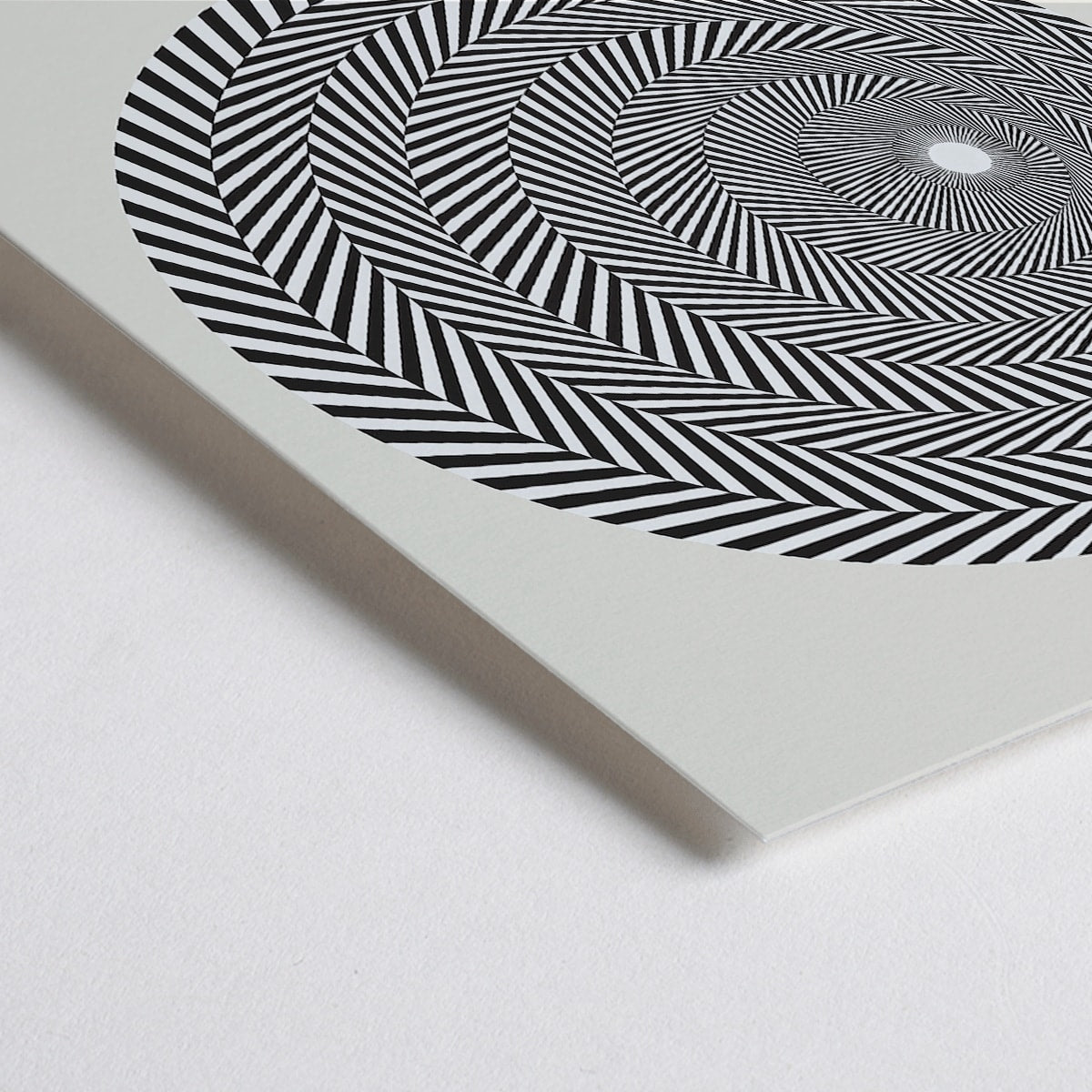 Closeup detail of Bridget Riley Blaze Exhibition Poster featuring hypnotic black and white spiral geometric design on light background