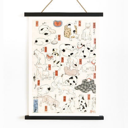 Playful and resting cats in traditional Japanese ukiyo-e art by Utagawa Kuniyoshi featuring multiple cats in various poses with Japanese elements, with wooden magnetic frame on white background