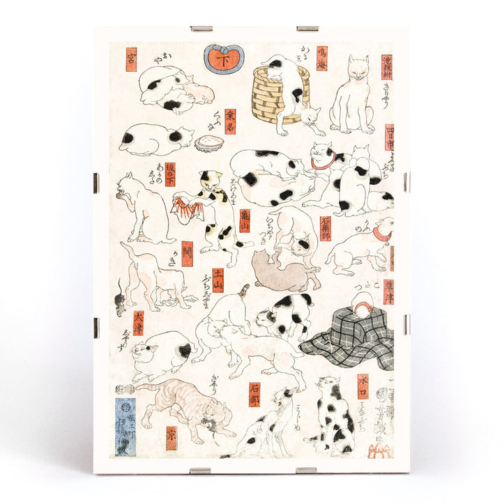 Playful and resting cats in traditional Japanese ukiyo-e art by Utagawa Kuniyoshi featuring multiple cats in various poses with Japanese elements, framed and displayed in modern living room decor