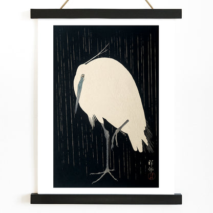 White egret standing in the rain art print poster with dark background by Ohara Koson, with wooden magnetic frame on white background