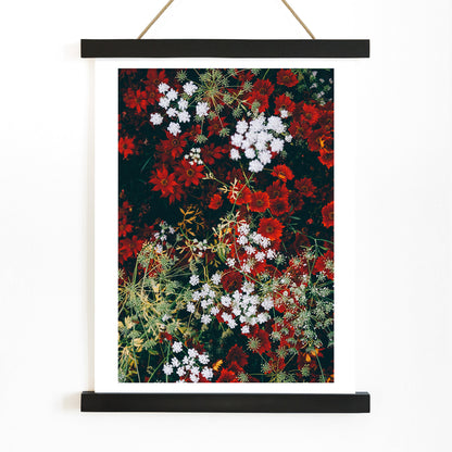 Overhead shot of red and white flowers artwork poster, with wooden magnetic frame on white background