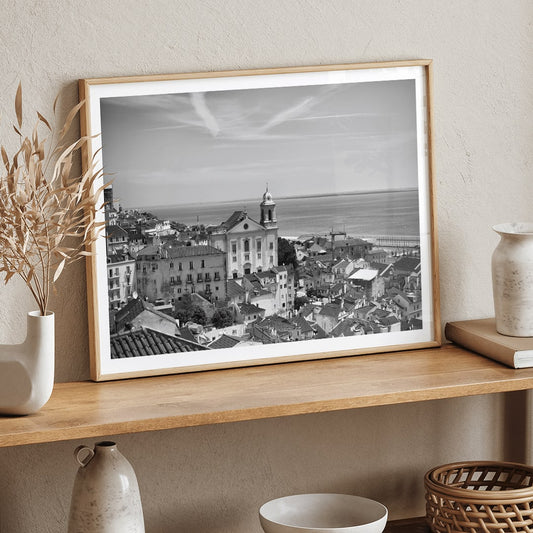 Lisbon Old City Landscape Black and White Picture 1 showing historic buildings rooftops and ocean view waterfront poster, framed and displayed in home decor