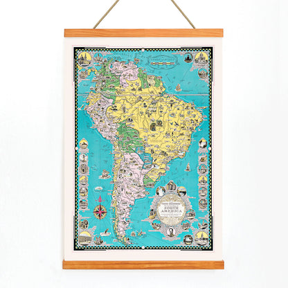 Colorful illustrated map poster of South America by Ernest Dudley Chase titled The Good Neighbor of South America, with wooden magnetic frame on white background