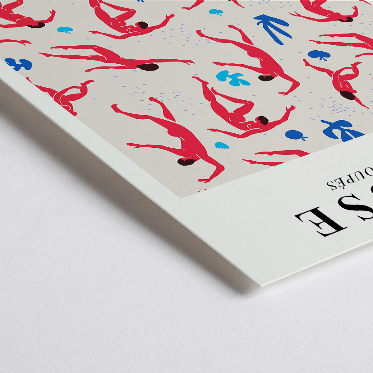 Closeup detail of Henri Matisse Dancing Figures Exhibition Poster with vibrant red and blue design featuring red cut out figures on a patterned background with exhibition details