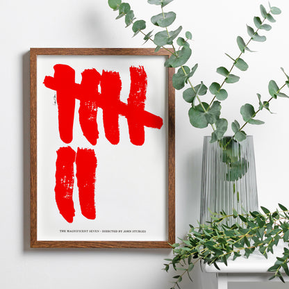 Minimalist movie poster for The Magnificent Seven by Saul Bass with bold red brushstroke tally marks on white background, framed and displayed in home decor
