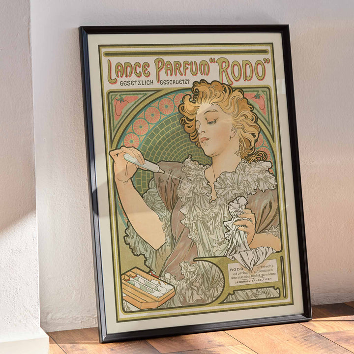 Alphonse Mucha Lance parfum Rodo poster Art Nouveau woman with flowing hair floral border soft green gold tones, framed and displayed in modern living room decor