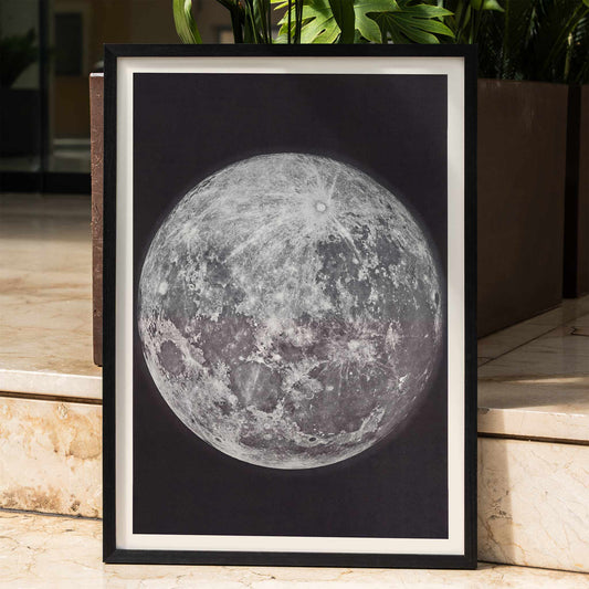 Photograph and poster of the moon by Gerard Kuiper showing detailed lunar surface framed in black and white border, framed and displayed in home decor