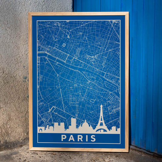 Minimalist Paris city map artwork and poster featuring detailed blue and white map with Eiffel Tower and prominent Paris landmarks, framed and displayed in home decor