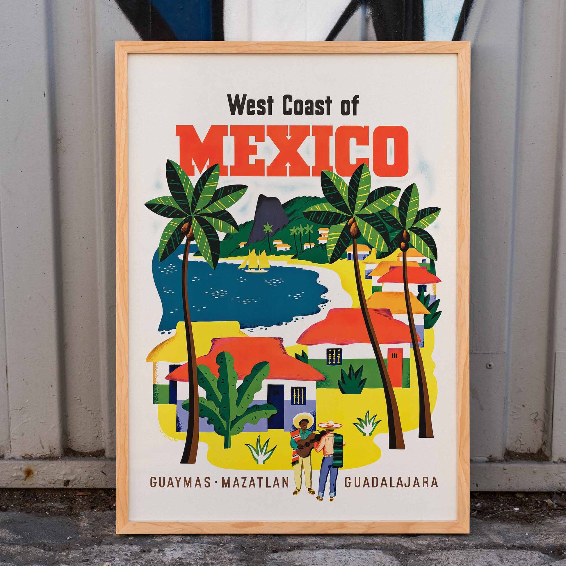 Colorful vintage travel poster of the West Coast of Mexico by Ray Bethers with palm trees and vibrant colorful houses, framed and displayed in home decor