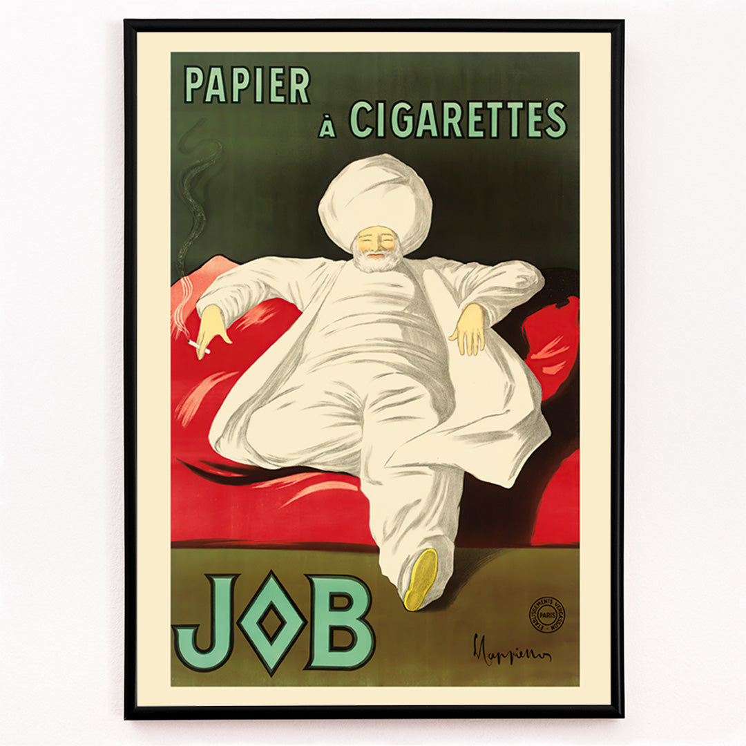 Closeup detail of Cigarette Rolling Paper Job poster by Leonetto Cappiello showing a relaxed man in white robes and turban reclining with a cigarette on a red couch