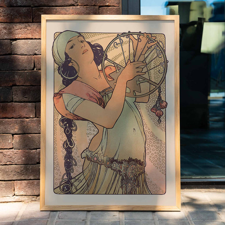 Alphonse Mucha Salome Art Nouveau poster elegant woman holding decorated circular motif in soft peach beige and green tones, framed and displayed in home decor