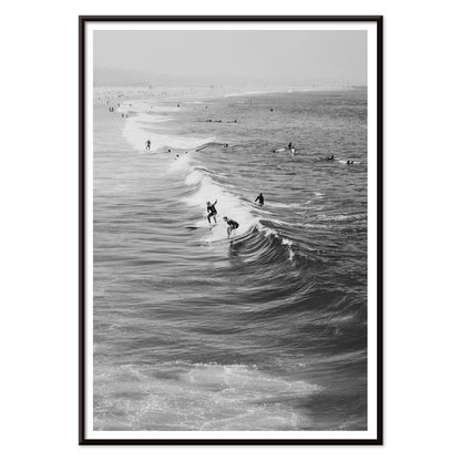 Black and white surfers riding waves at Venice Beach coastal wall art poster ideal for home decor, with black aluminium frame on white background