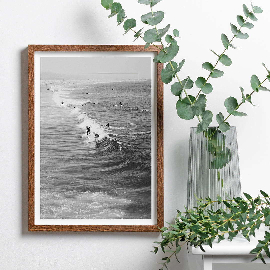 Black and white surfers riding waves at Venice Beach coastal wall art poster ideal for home decor, framed and displayed in home decor