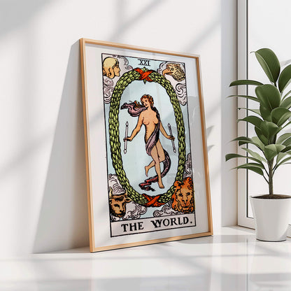 The World Tarot card by Rider Waite showing a central figure within an oval wreath surrounded by four figures representing the fixed signs, framed and displayed in home decor