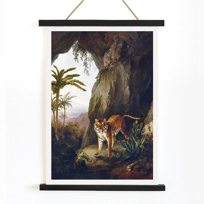 Tiger in a Cave painting by Jacques Laurent Agasse showing a tiger standing in a cave entrance surrounded by lush vegetation, with wooden magnetic frame on white background