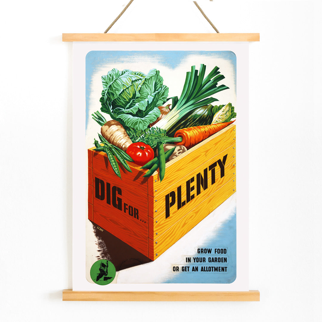 Vintage poster of a crate of fresh garden vegetables with text Dig for Plenty promoting self-sufficiency artwork by Mary Le Bon, with wooden magnetic frame on white background